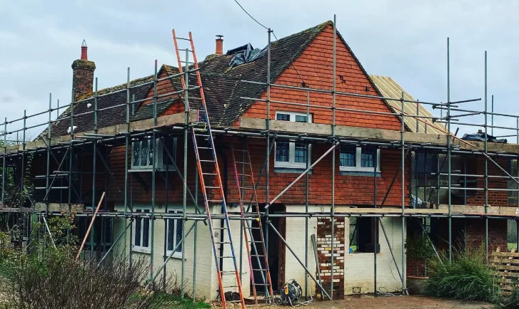 Full elevation scaffolding on a large detached period property during roof replacement in West Sussex by A-Star Scaffolding Southern Ltd