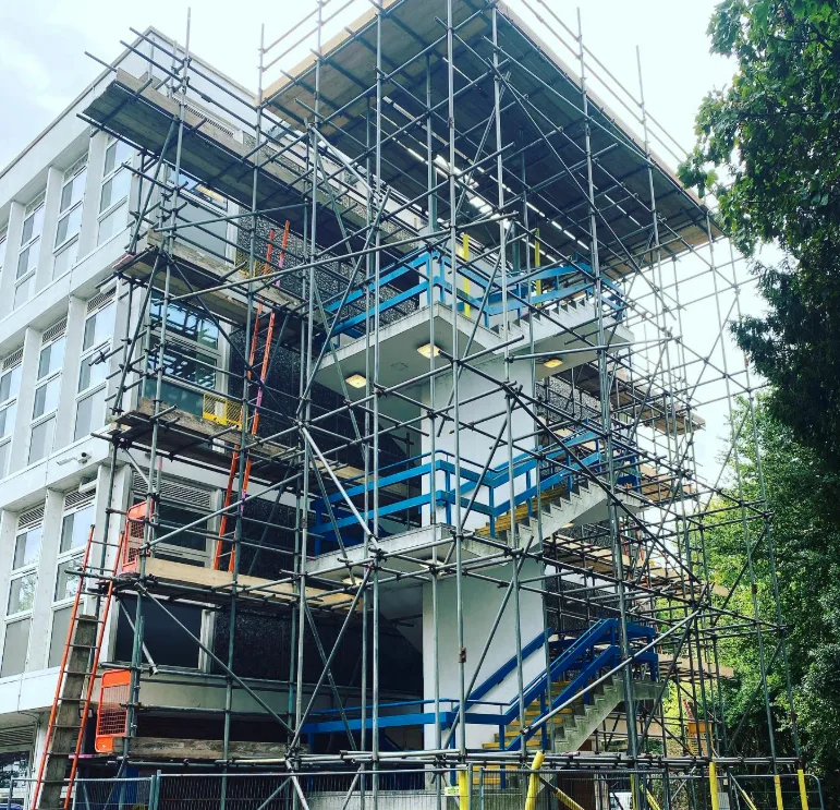 Alt Text Large-scale commercial scaffolding with stair towers on a multi-storey development in West Sussex by A-Star Scaffolding Southern Ltd