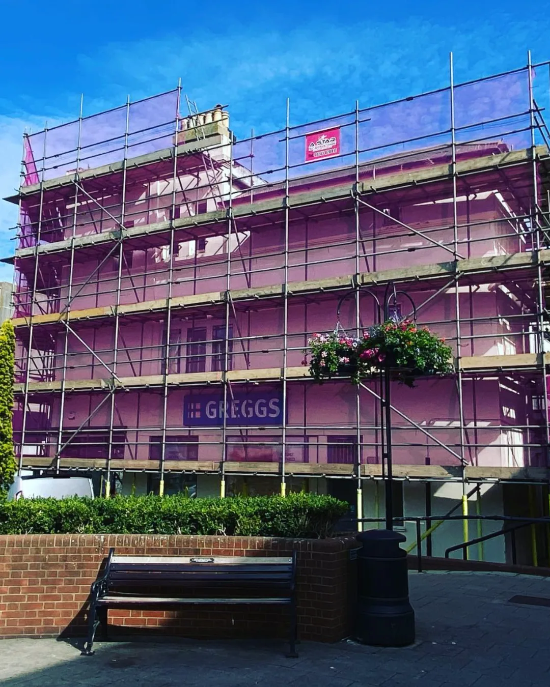 Commercial scaffolding with full debris netting on a town centre building in West Sussex by A-Star Scaffolding Southern Ltd