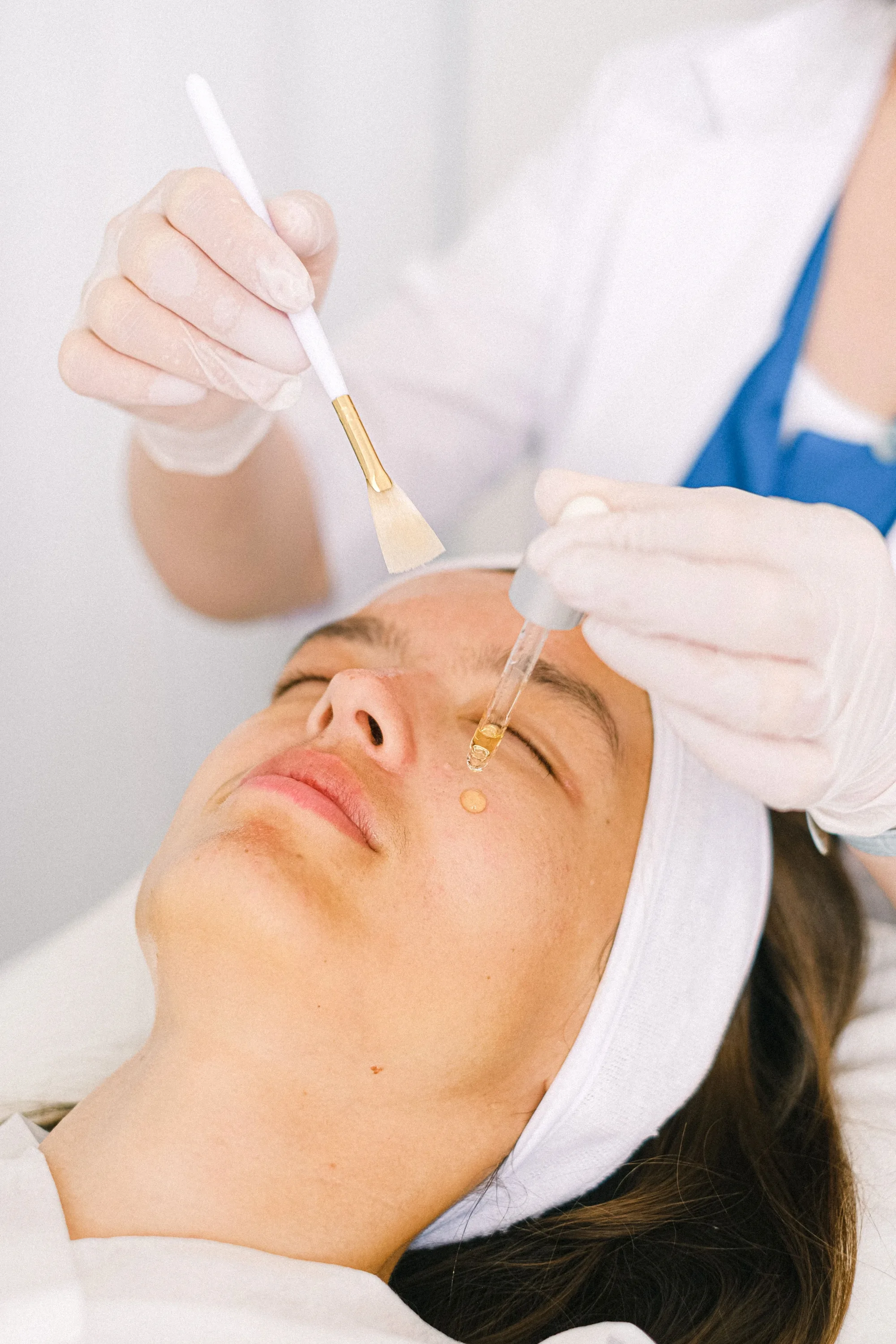 Facial skincare treatment being applied with dropper and brush at Novauria Aesthetics studio in Ashford, Kent