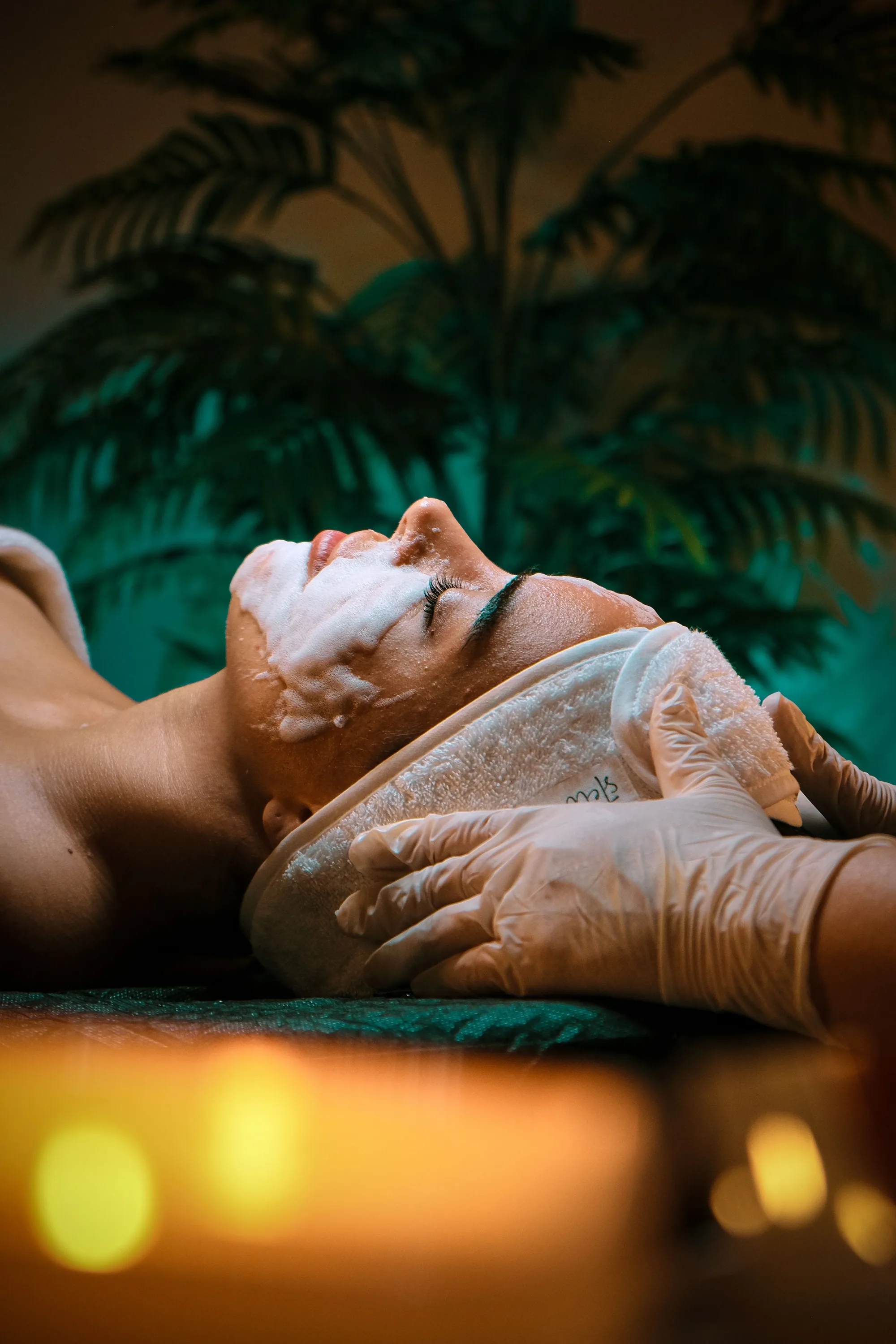 A client relaxing during a facial cleanse, illustrating the calm, restorative experience regular facials offer.