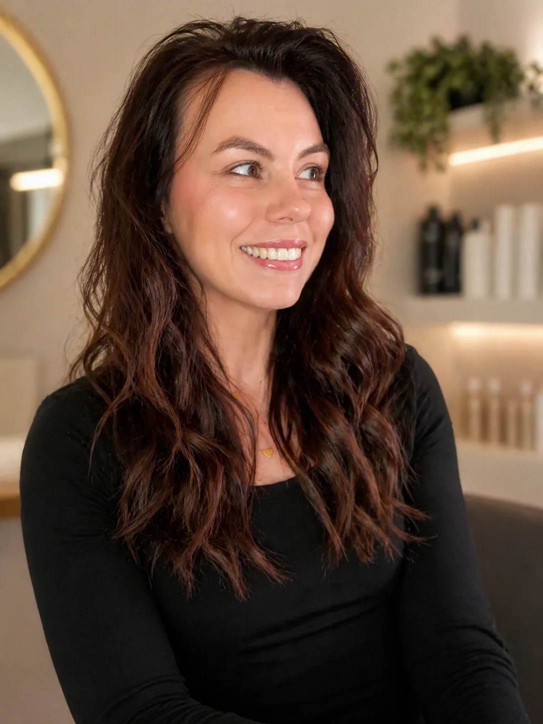 Liz, founder of Novauria Aesthetics, laughing warmly in her Ashford treatment room
